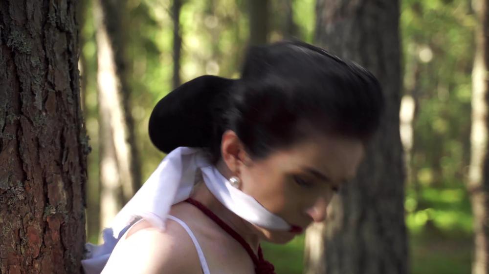 The Girl Is Tied To A Tree In The Forest