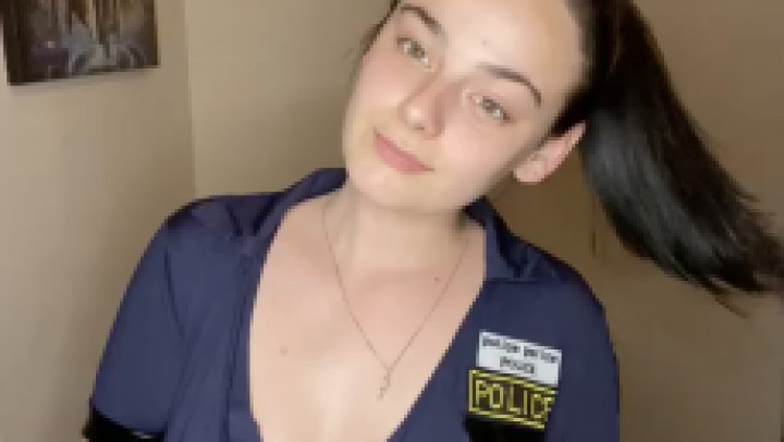 Teen police officer plays with toy